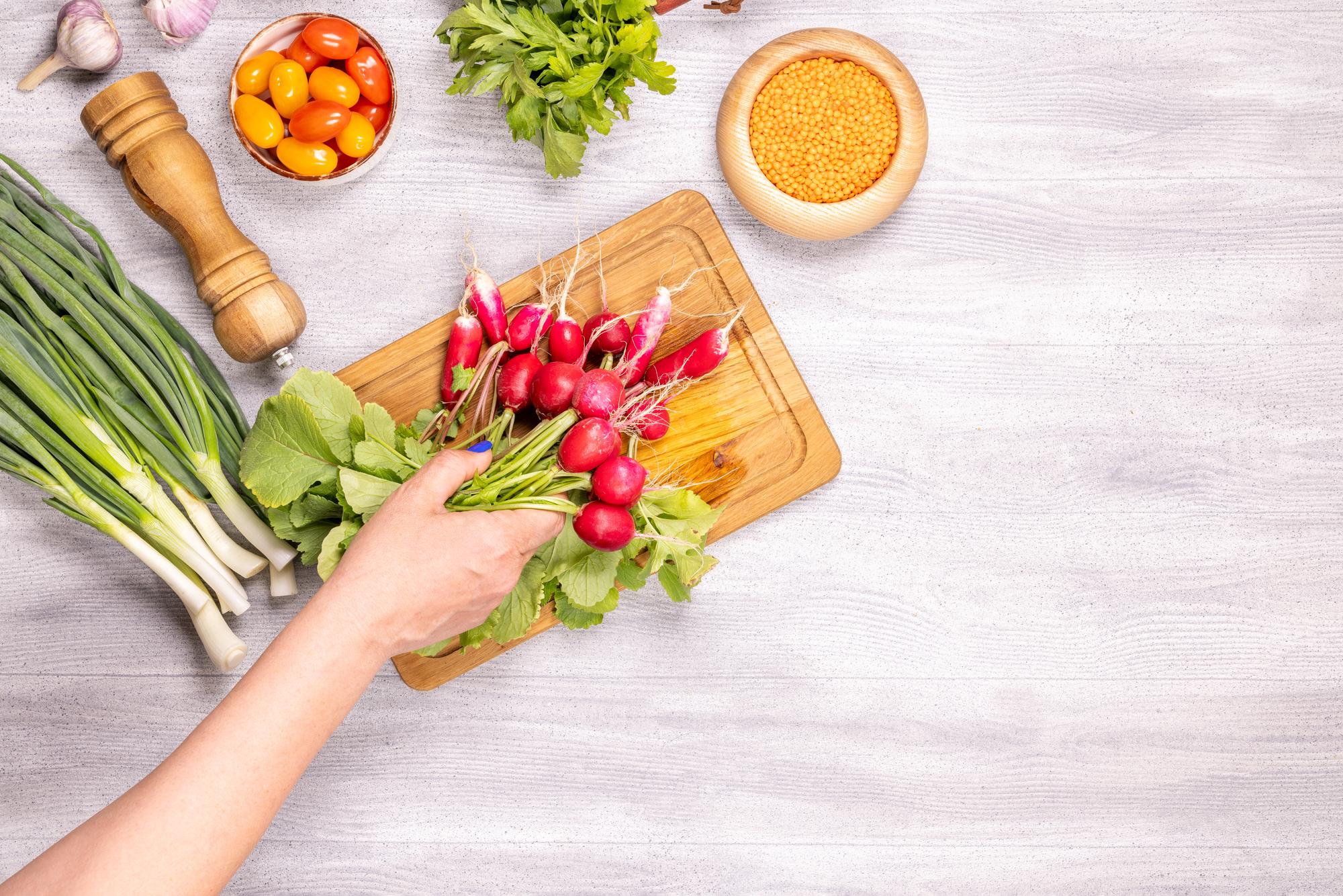 Hands preparing ingredients on a wooden table